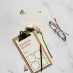 Realistic Notebook Mockup with Flower and glasses