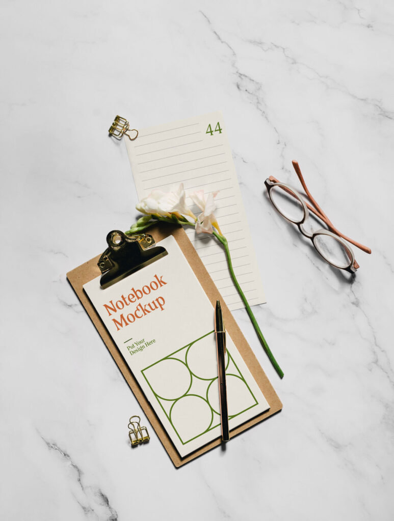 Realistic Notebook Mockup with Flower and glasses