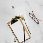 Realistic Notebook Mockup with Flower and glasses
