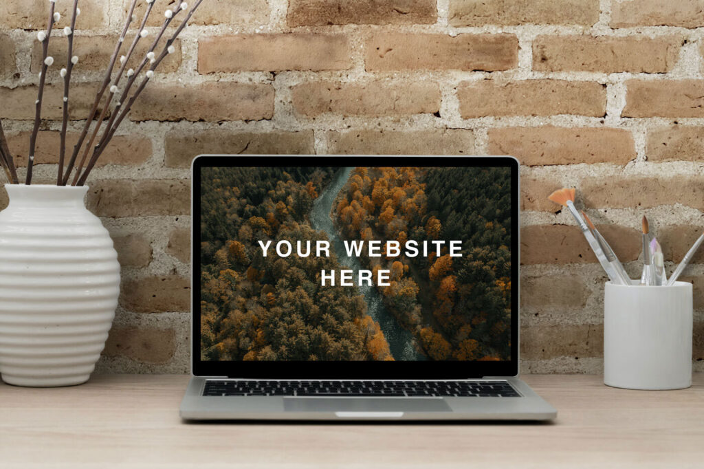 Realistic MacBook Workspace Mockup Against the Brick Wall