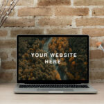 Realistic MacBook Workspace Mockup Against the Brick Wall