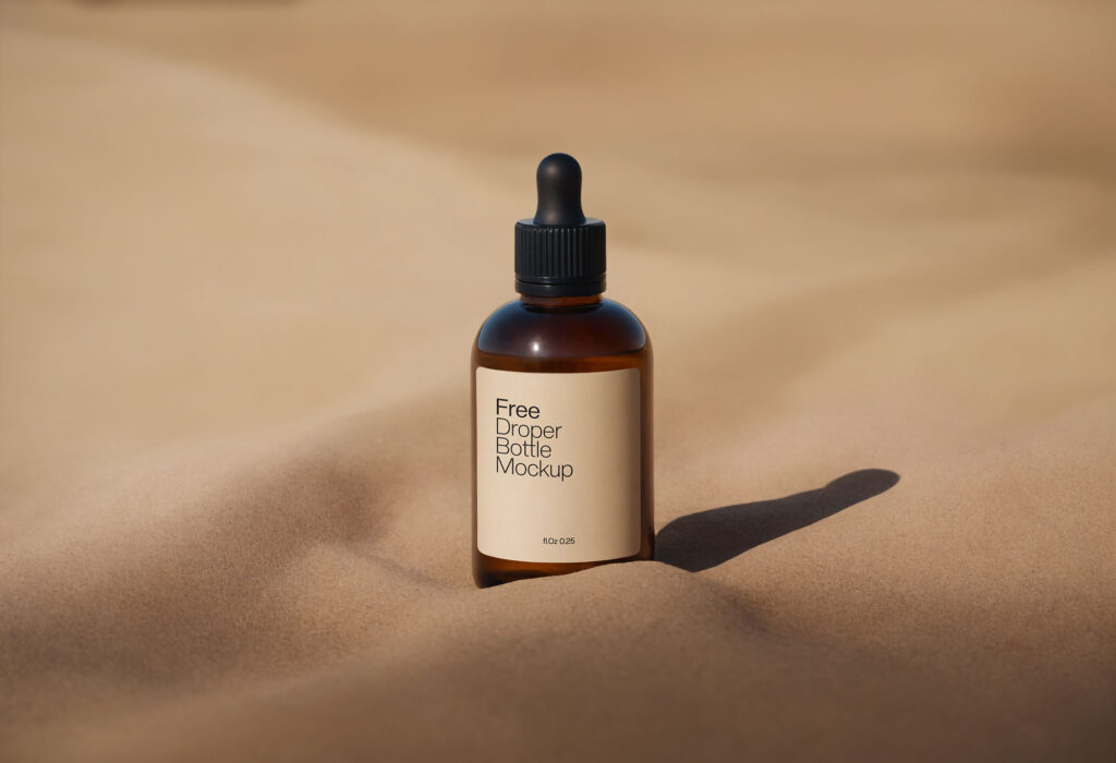 Amber Dropper Bottle Mockup with Sand Background