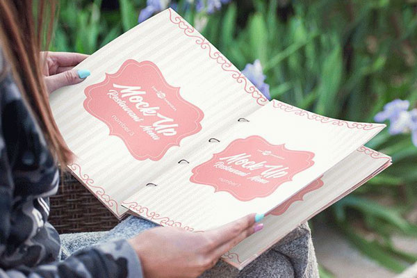 Restaurant Menu Mockup in Hands of a Woman