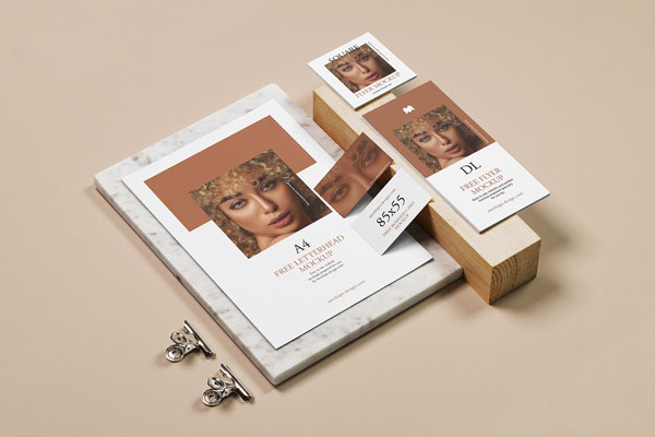 Set of Stationery Mockups Laid on a Slab of Stone and Block of Wood in Perspective