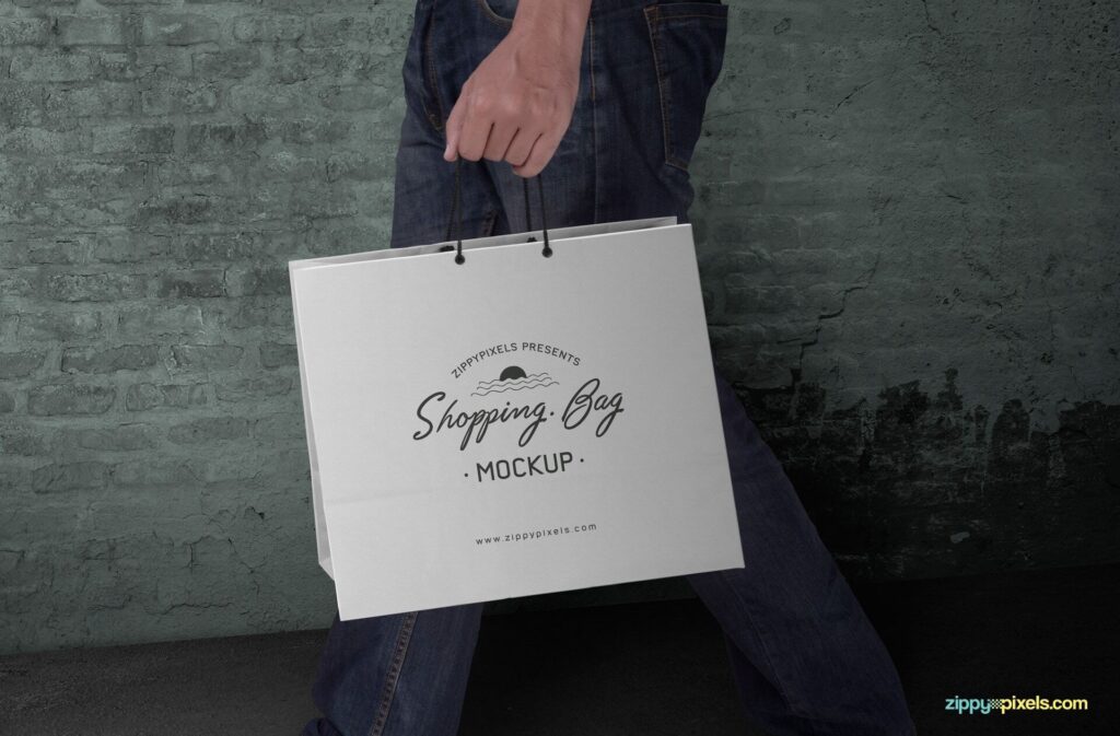 Side View Man Holding a Paper Shopping Bag Mockup