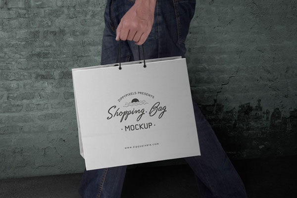 Side View Man Holding a Paper Shopping Bag Mockup