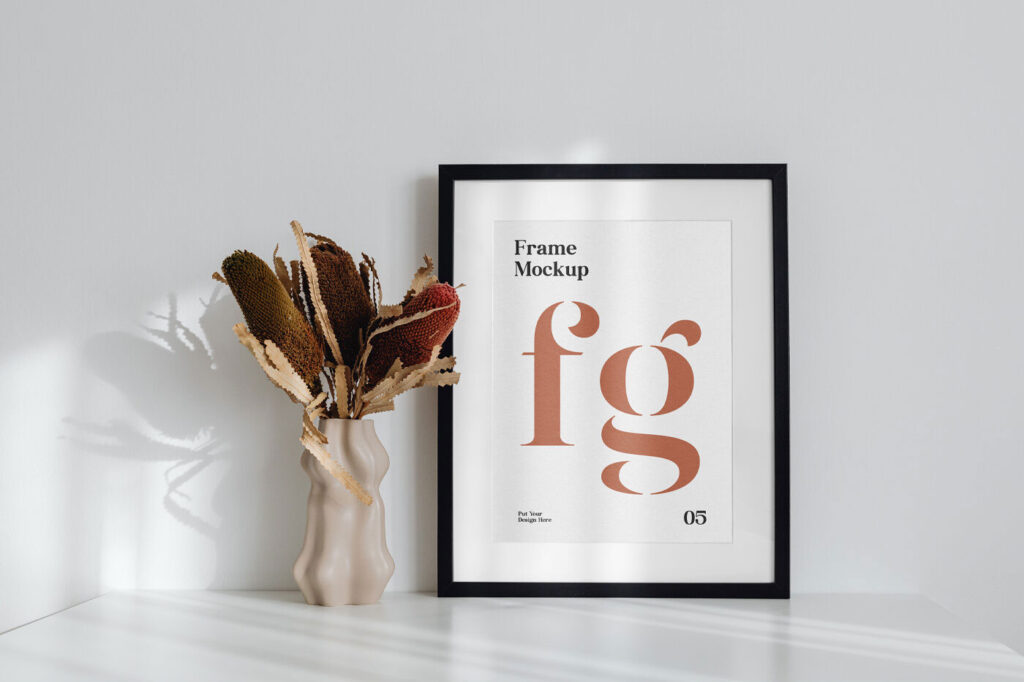 Simple Frame on the Desk Mockup Next to a Flower