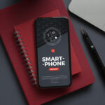 Smartphone Mockup Laid on Notebook in Top View