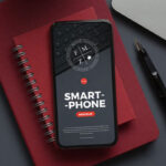 Smartphone Mockup Laid on Notebook in Top View