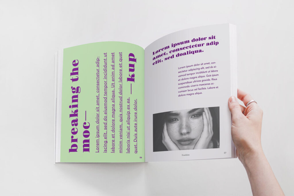 Spread Magazine Held by a Hand Mockup