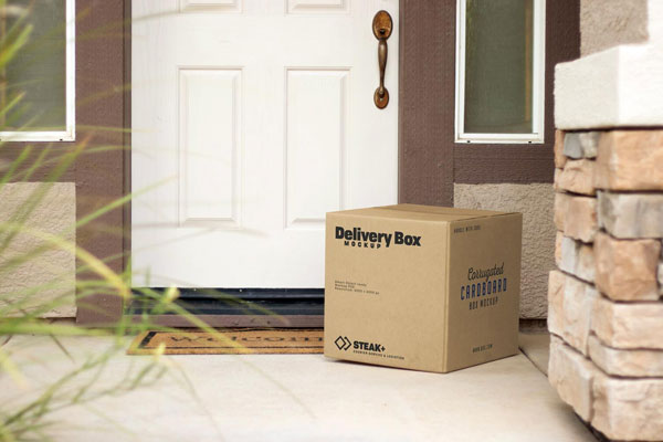 Square Delivery Box In front of a House Door Mockup