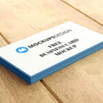 Stack of Professional Business Cards on a Wooden Surface Mockup