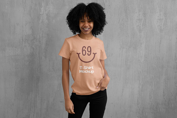 T-Shirt Mockup Featuring a Woman in Front of a Wall