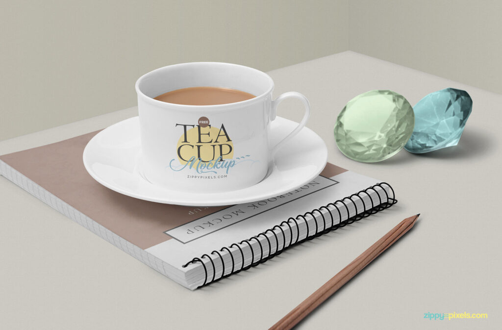 Tea Cup Mockup Featuring Ringed Notebook, Gemstones and a Pencil