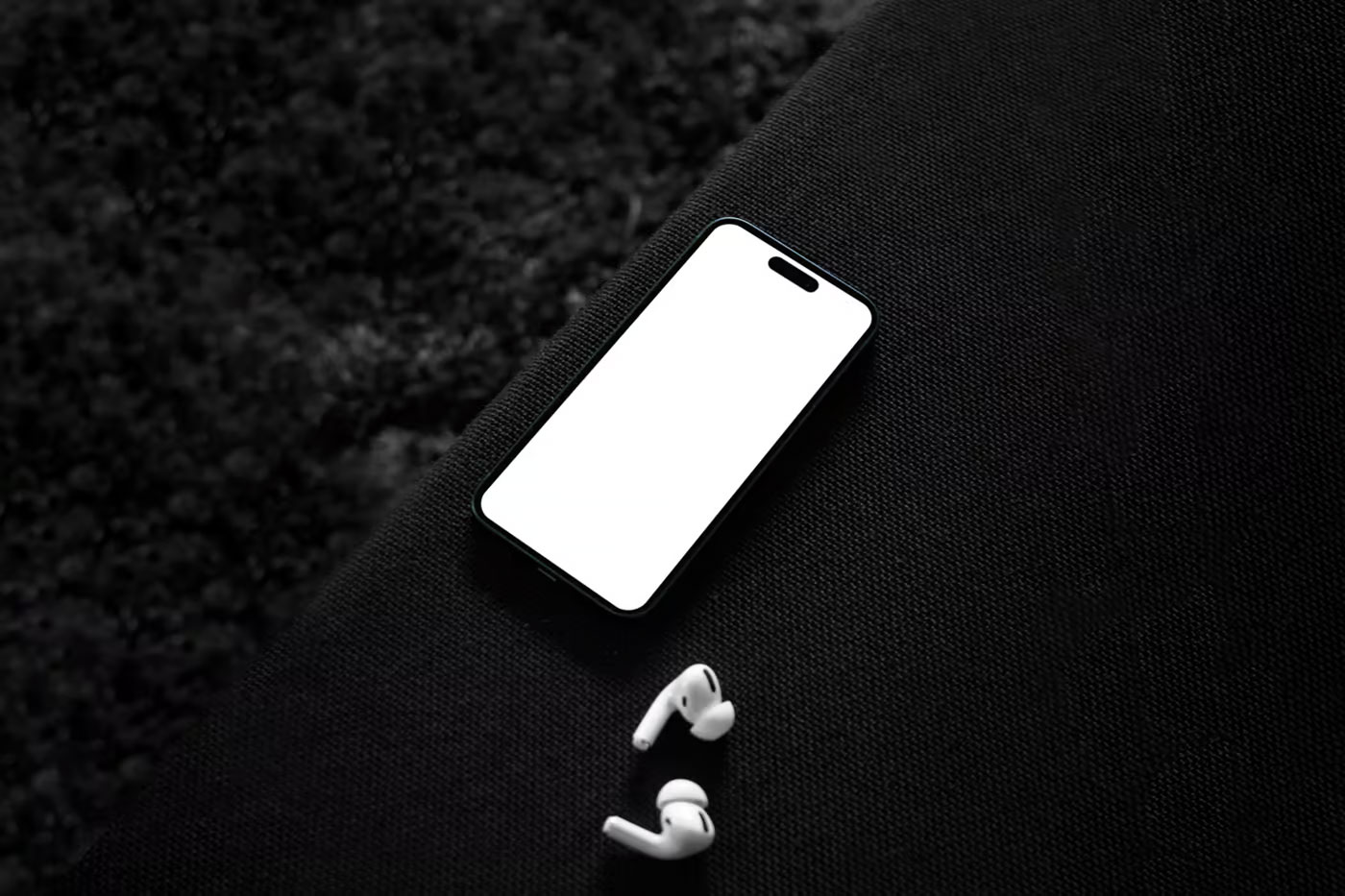 Free Top Sight of iPhone 14 Pro Mockup on Sofa PSD Template