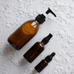 Top View Different Sizes Cosmetics Amber Bottles Mockup