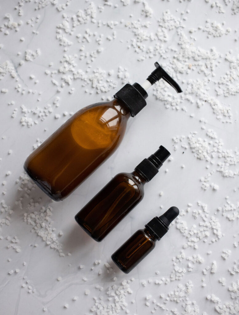 Top View Different Sizes Cosmetics Amber Bottles Mockup