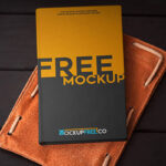 Top View Hardcover Notebook Laid Down on Leather Mockup