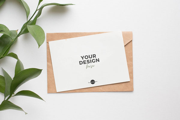 Top View Invitation Card on Envelope Mockup with Plant