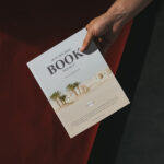 Top View Male Hand Holding Book Mockup