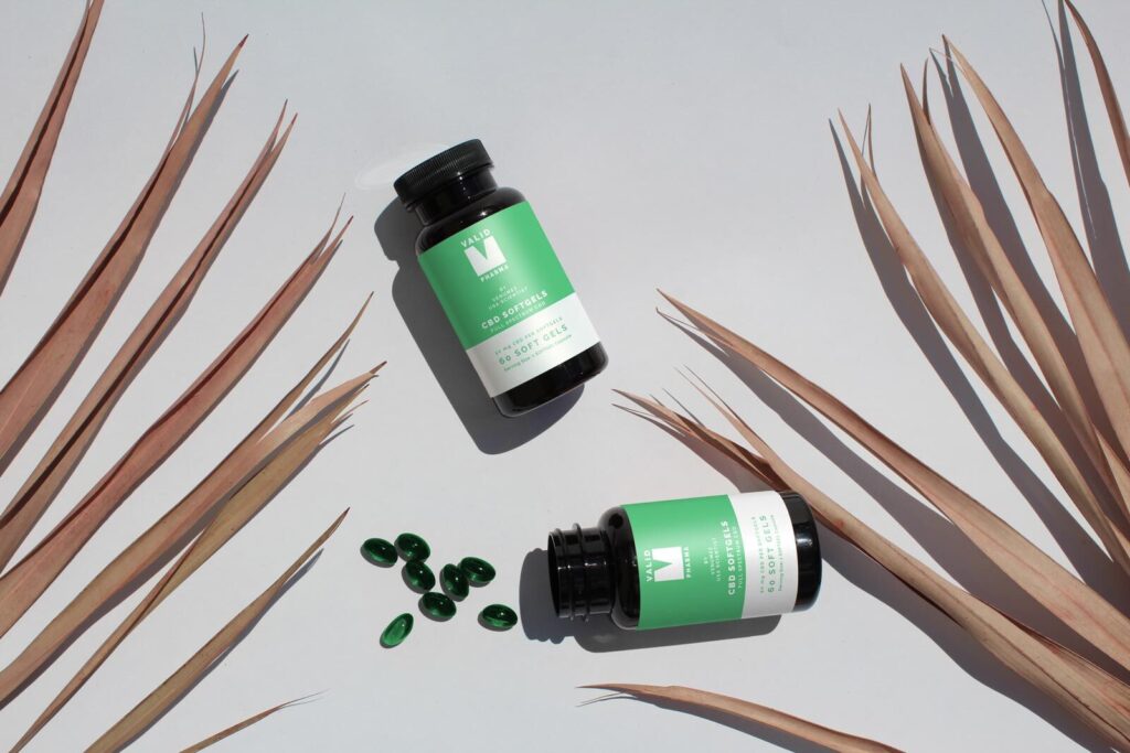 Top View Mockup of Two Soft Capsule Bottles on Floor