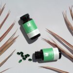 Top View Mockup of Two Soft Capsule Bottles on Floor