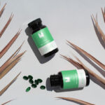 Top View Mockup of Two Soft Capsule Bottles on Floor