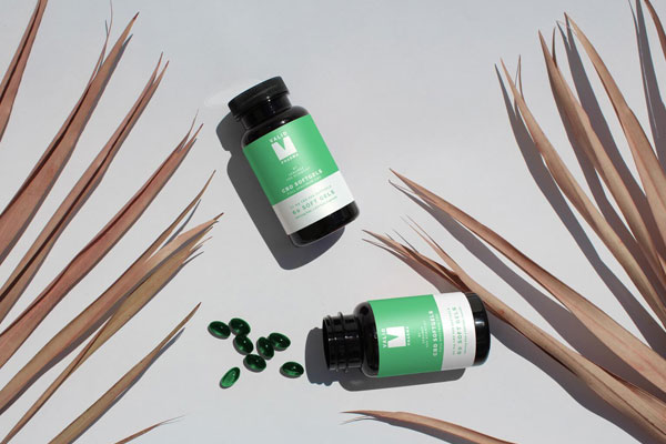 Top View Mockup of Two Soft Capsule Bottles on Floor
