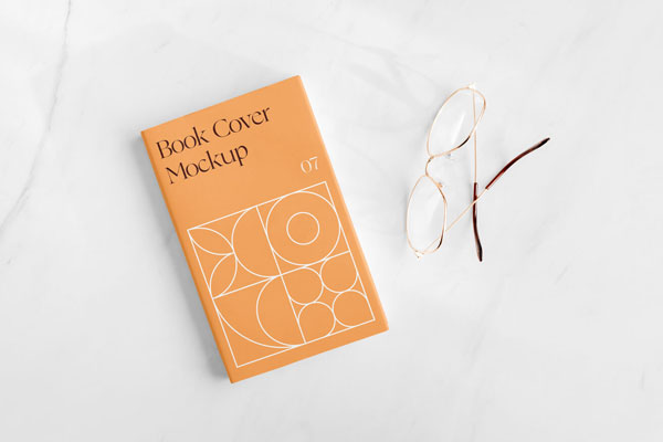 Top View of a Book Cover on Marble Surface Mockup