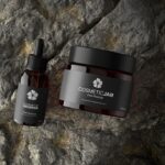 Top View of a Cosmetic Jar and Dropper on a Rock Mockup