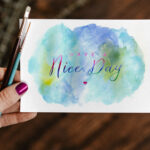 Top View of A Greeting Card Mockup In A Woman’s Hand