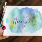 Top View of A Greeting Card Mockup In A Woman’s Hand