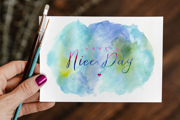 Top View of A Greeting Card Mockup In A Woman’s Hand