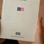 Top View of a Hand Holding Hardcover Book Mockup
