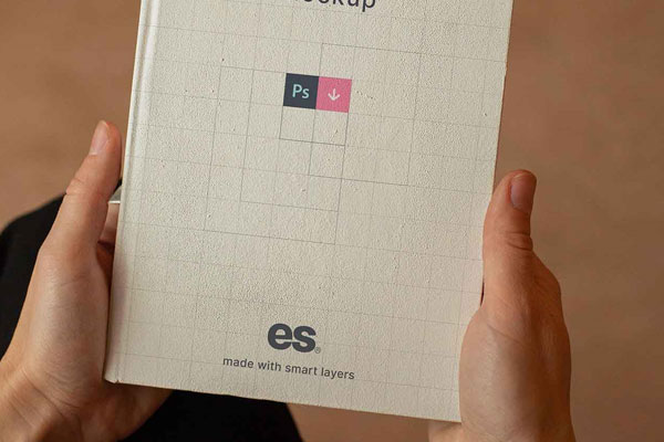 Top View of a Hand Holding Hardcover Book Mockup