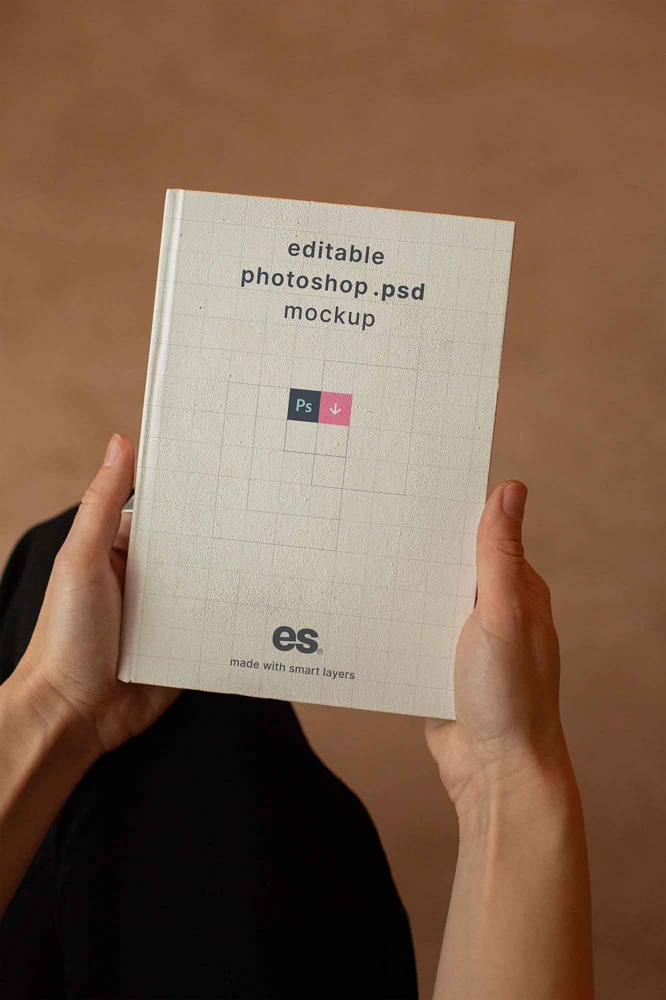 Top View of a Hand Holding Hardcover Book Mockup FREE PSD