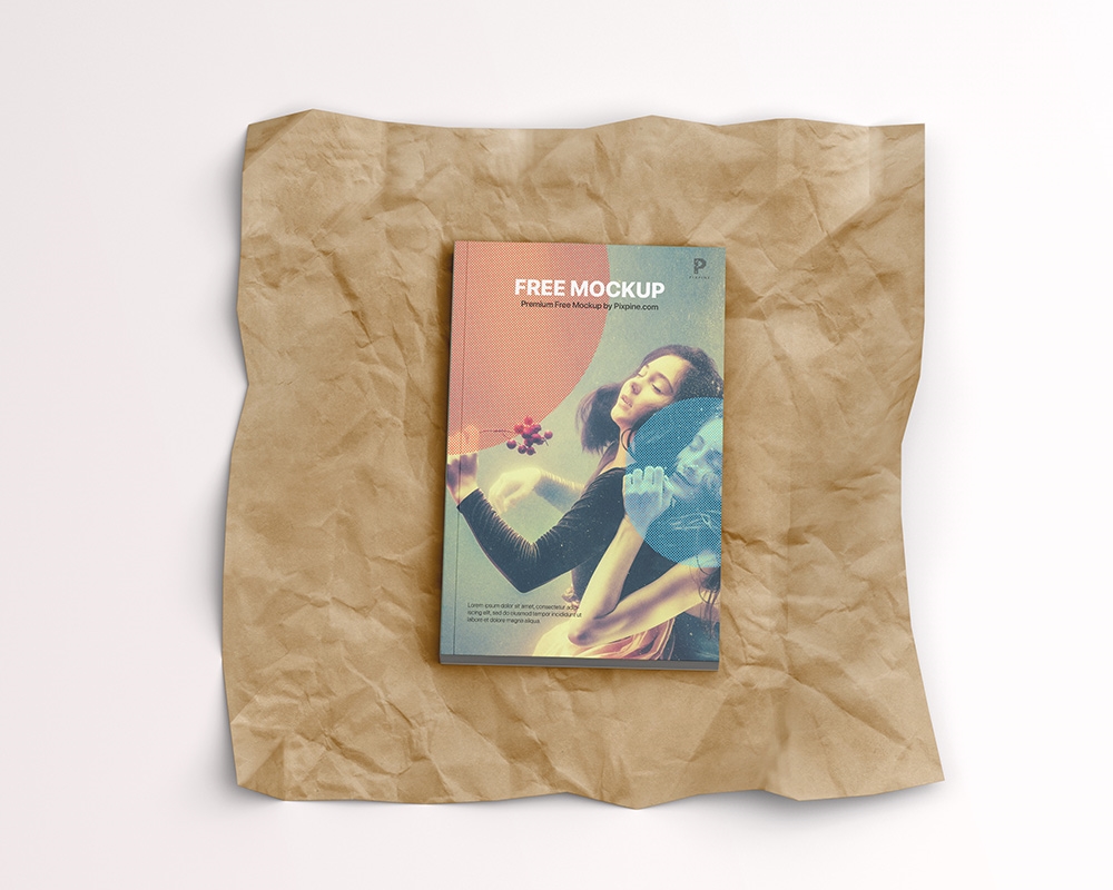 Top View of a Softcover Book on a Wrinkled Paper Mockup