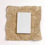 Top View of a Softcover Book on a Wrinkled Paper Mockup