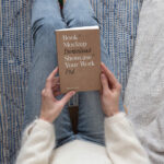 Top View of a Woman Holding Book Cover Mockup