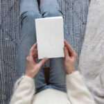 Top View of a Woman Holding Book Cover Mockup