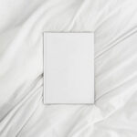 Top View of an A4 Book Hardcover on a Sheet Mockup