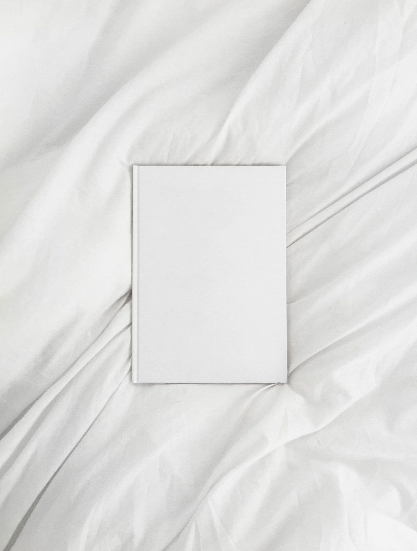 Top View of an A4 Book Hardcover on a Sheet Mockup FREE PSD