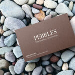Top View of Business Card Mockup on Pebbles