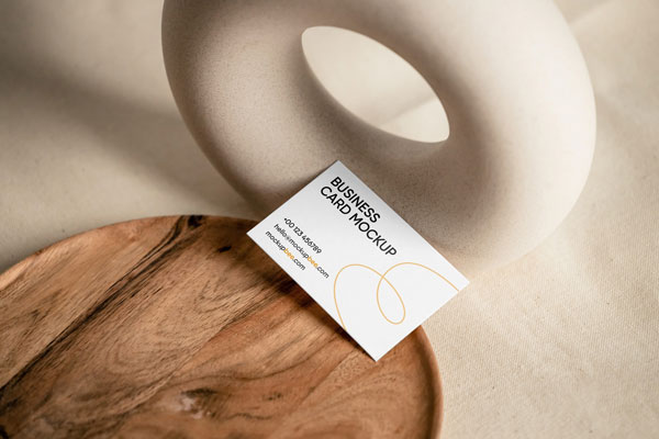 Top View of Business Card Mockup on Wooden Plate