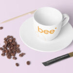 Top View of Coffee Cup Mockup Featuring Spread Coffee Beans