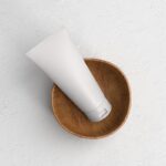 Top View of Cosmetic Tube Mockup on a Wooden Cup