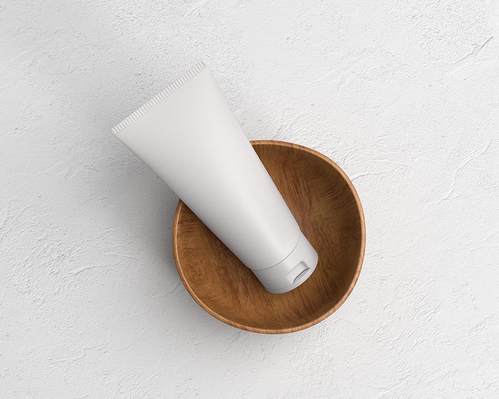 Top View of Cosmetic Tube Mockup on a Wooden Cup