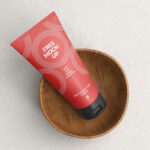 Top View of Cosmetic Tube Mockup on a Wooden Cup