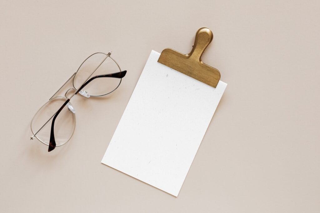 Top View of Elegant Card Mockup Featuring Clip and Glasses