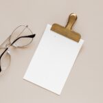 Top View of Elegant Card Mockup Featuring Clip and Glasses